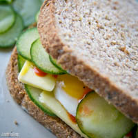 Fried egg, monterey jack cheese, and pickled cucumber sandwich with sriracha